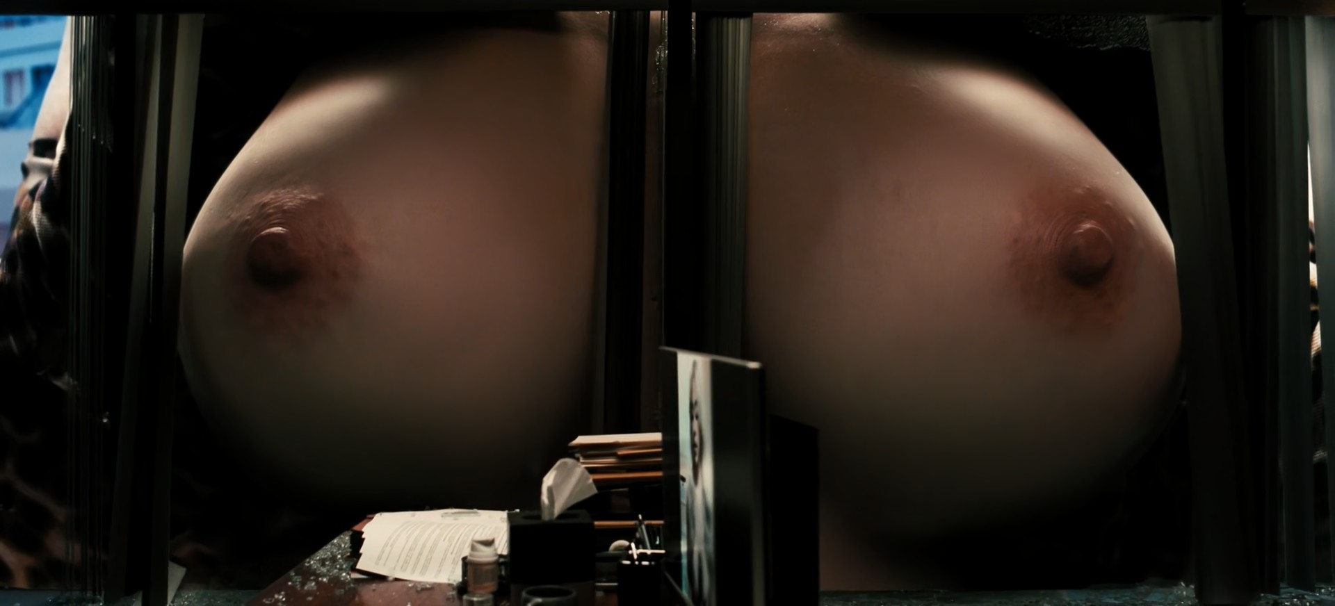 Sydney Sweeney bursts topless through shattered office windows as giant Cassie Howard forces her naked boobs into the building in Euphoria’s wild fantasy sequence.