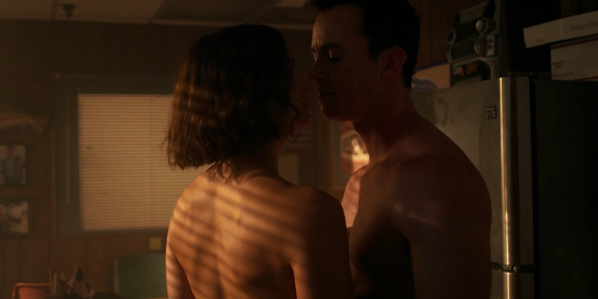 Snapshot from Teen Wolf: The Movie capturing a completely naked Shelley Hennig (actress) and Ryan Kelley (actor) in a close embrace during an intimate scene, exposing her bare back, side boob, and their naked bodies to the camera.